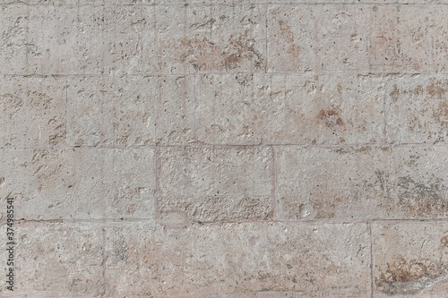 abstract background of an ancient plastered stone lined wall