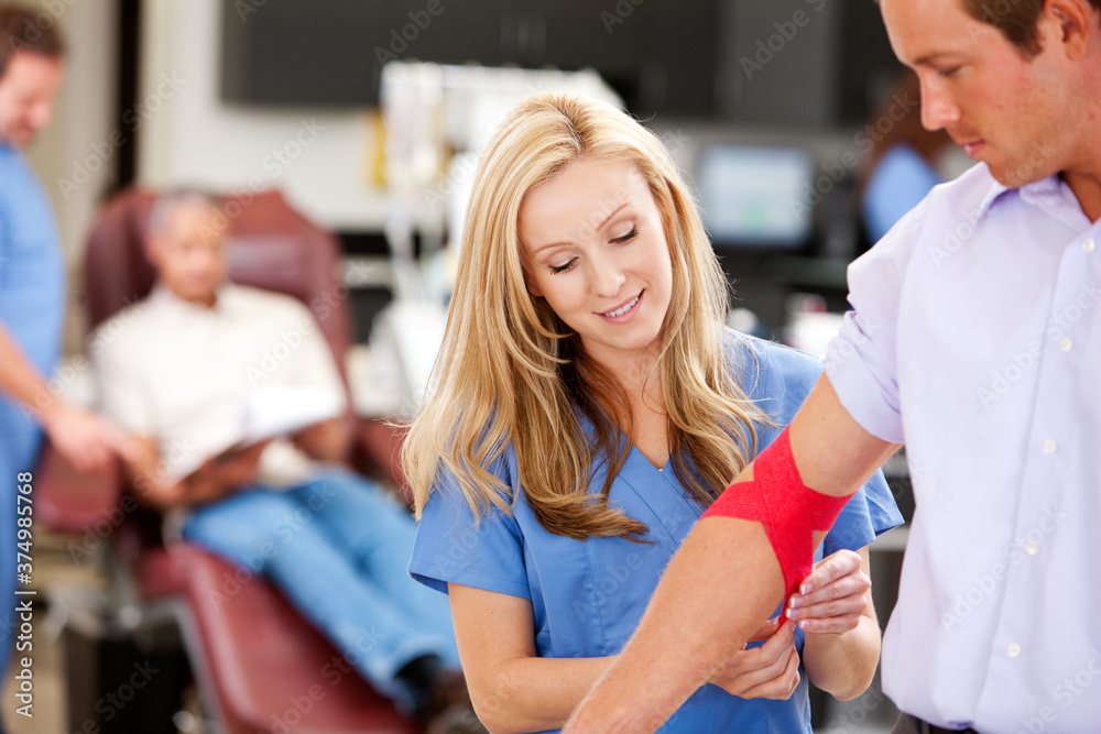 Blood Bank: Nurse Checks Bandage on Blood Donor