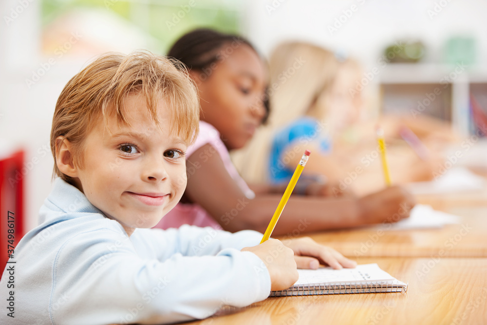 Classroom: Smart Boy Writing in Notebook Classroom: Smart Boy Writing in Notebook