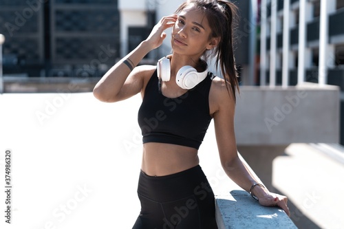 Female jogger resting while listening music © opolja