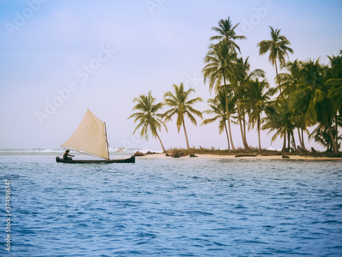 Traditional sailing at the palm covered islands of San Blas, Panama photo