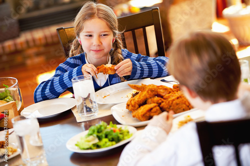 Family: Girl Listening To Music and Eating Chicken photo