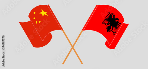 Crossed and waving flags of Albania and China
