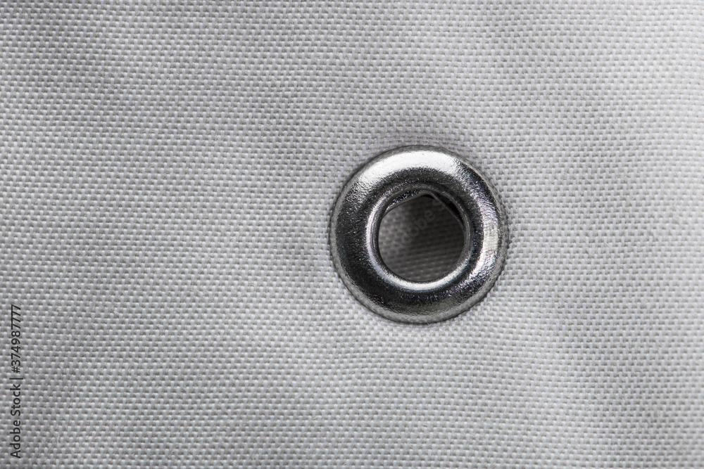 metal grommet on grey raincoat fabric