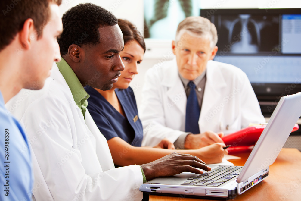 Doctors: Reviewing Data on a Laptop Doctors: Reviewing Data on a Laptop