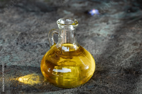 A bottle of oil on a dark background