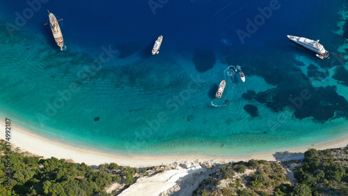 Fototapeta Naklejka Na Ścianę i Meble -  Aerial photo taken by drone of Caribbean tropical exotic steep cliff island bay with turquoise clear sea sandy beaches and rare limestone trees