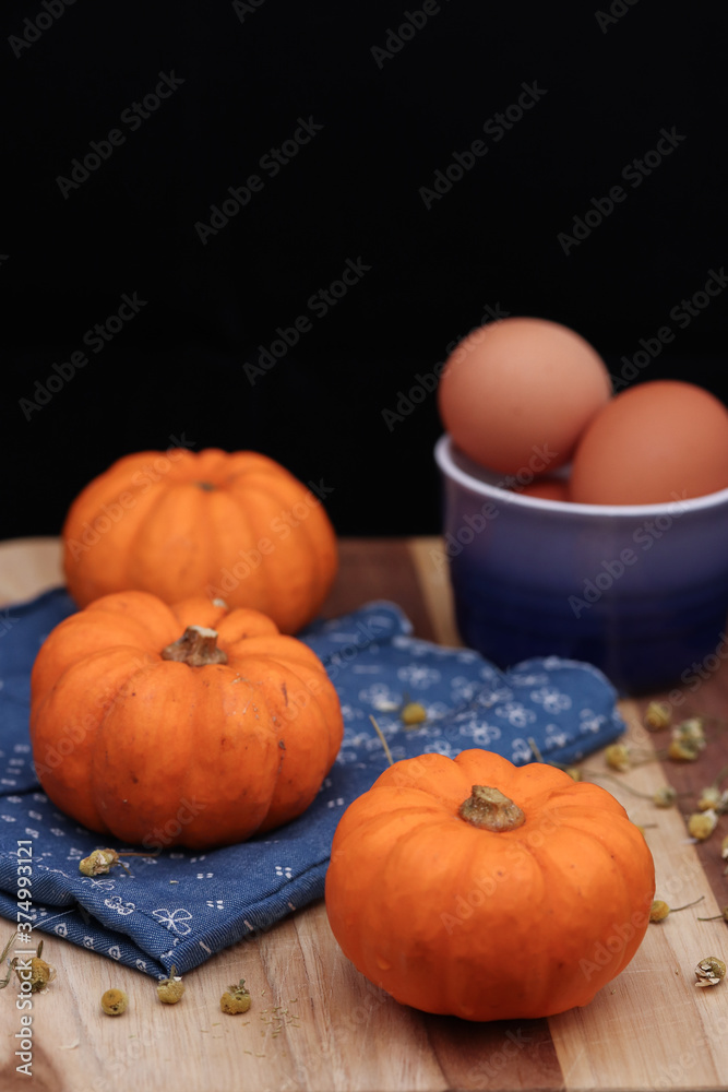 Pumpkins on a wooden table, orange and blue Pumpkins on a wooden table, orange and blue