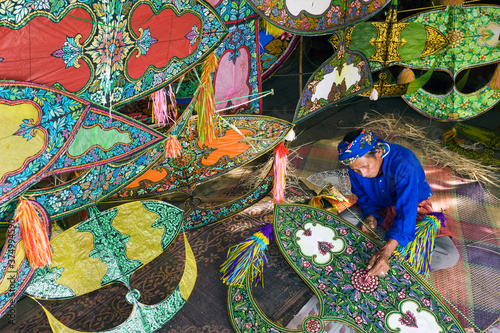 Asia, Malaysia, Kelantan State, Kota Bharu, Master Kite-maker constructing his world famous Kites photo