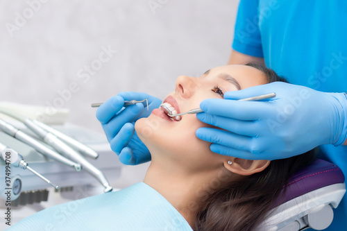 dentist examines the patients teeth at the dentist.