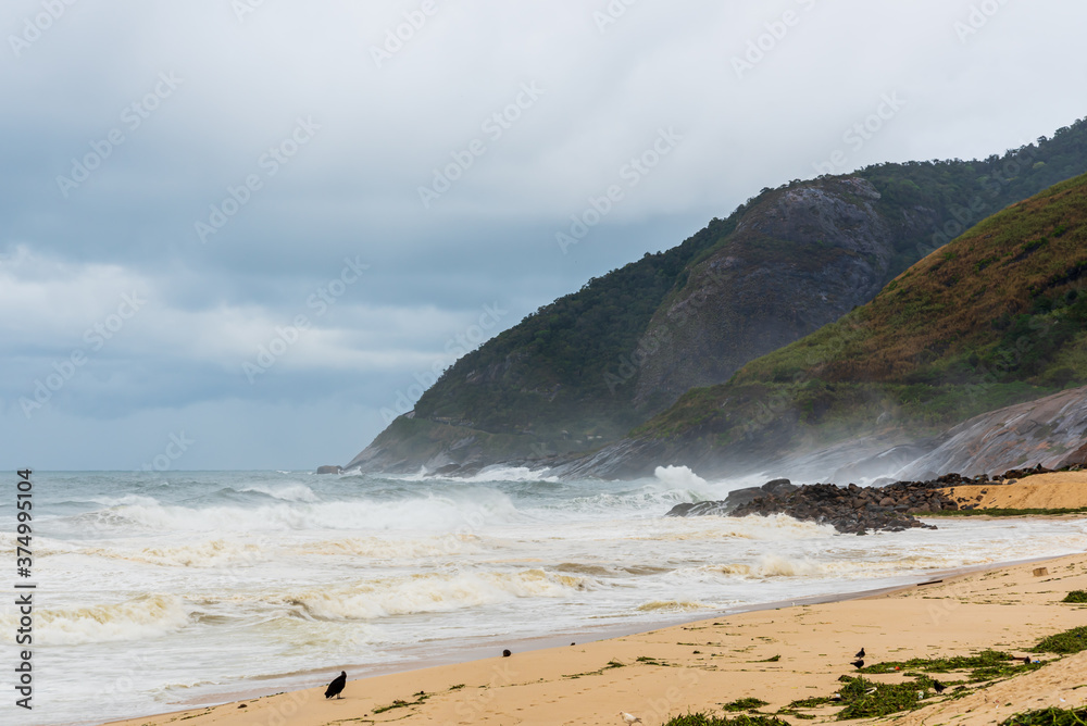 Waves hitting mountains´ rocks in a stormy day in Rio de Janeiro Waves hitting mountains´ rocks in a stormy day in Rio de Janeiro