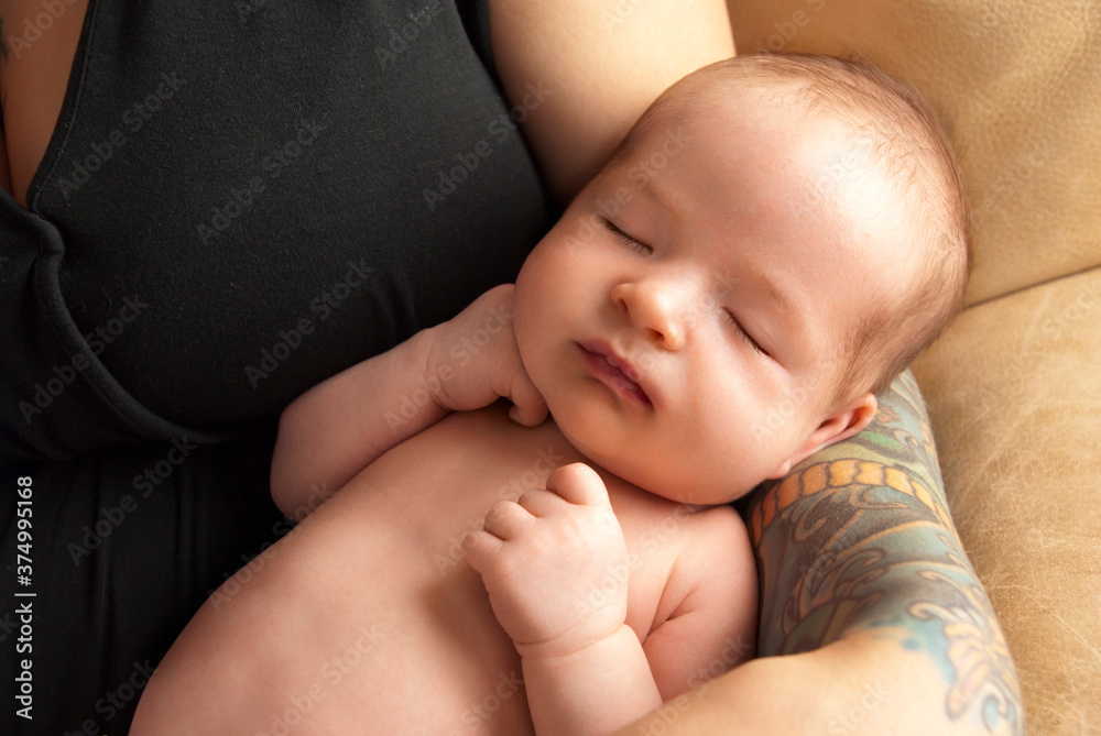 Sleeping newborn baby' boy in mother's arms Sleeping newborn baby' boy in mother's arms