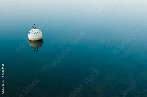 Wooden buoy floating on water surface