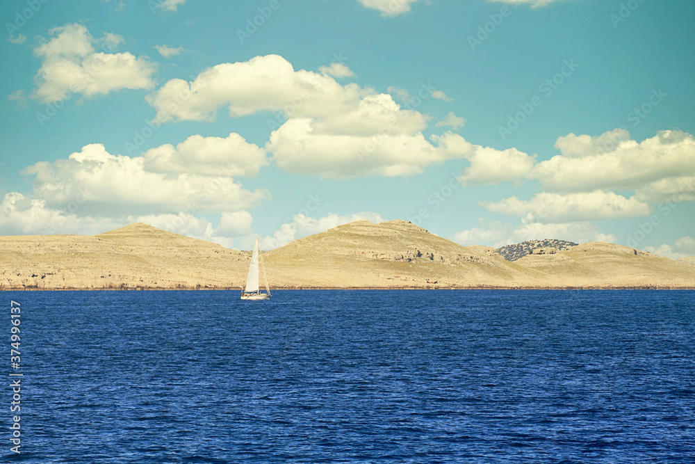 Sailing boat along the Kornati archipelago. Most of the Kornati island are deserted, but some small houses are inhabited in summer by tourists or fishers.