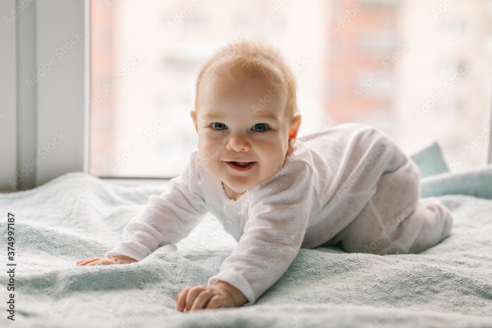 Baby 4-5 months old smiles, learns to stand on all fours and sways