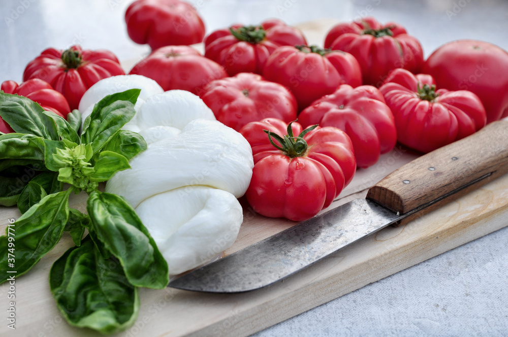 Food: Bulls heart tomatos, mozzarella cheese and basil Food: Bulls heart tomatos, mozzarella cheese and basil