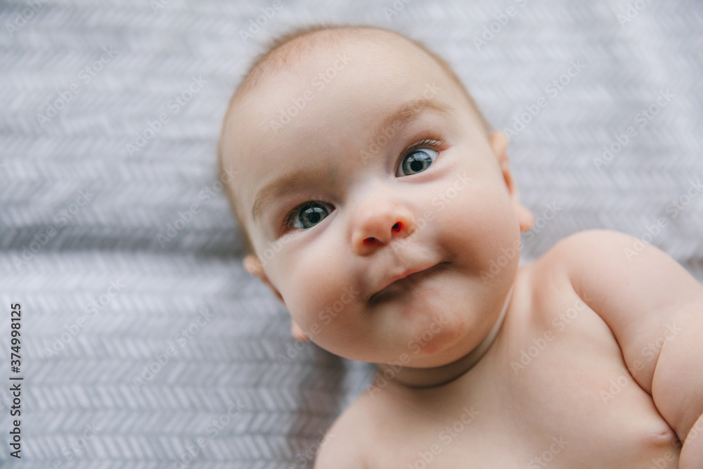 Newborn baby three months old smiles and lies. Psychomotor development and baby care Newborn baby three months old smiles and lies. Psychomotor development and baby care