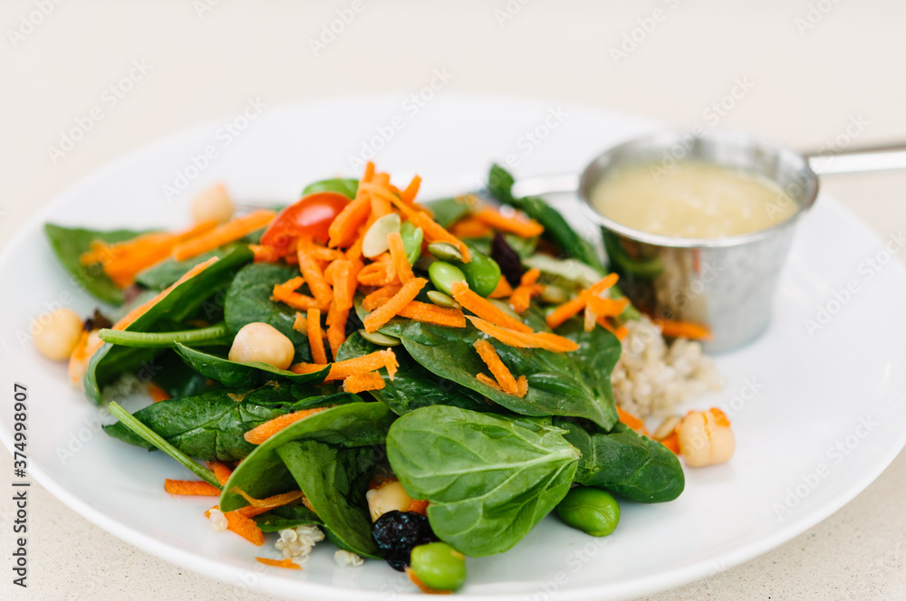 Spinach salad with carrots and chickpeas and dressing Spinach salad with carrots and chickpeas and dressing
