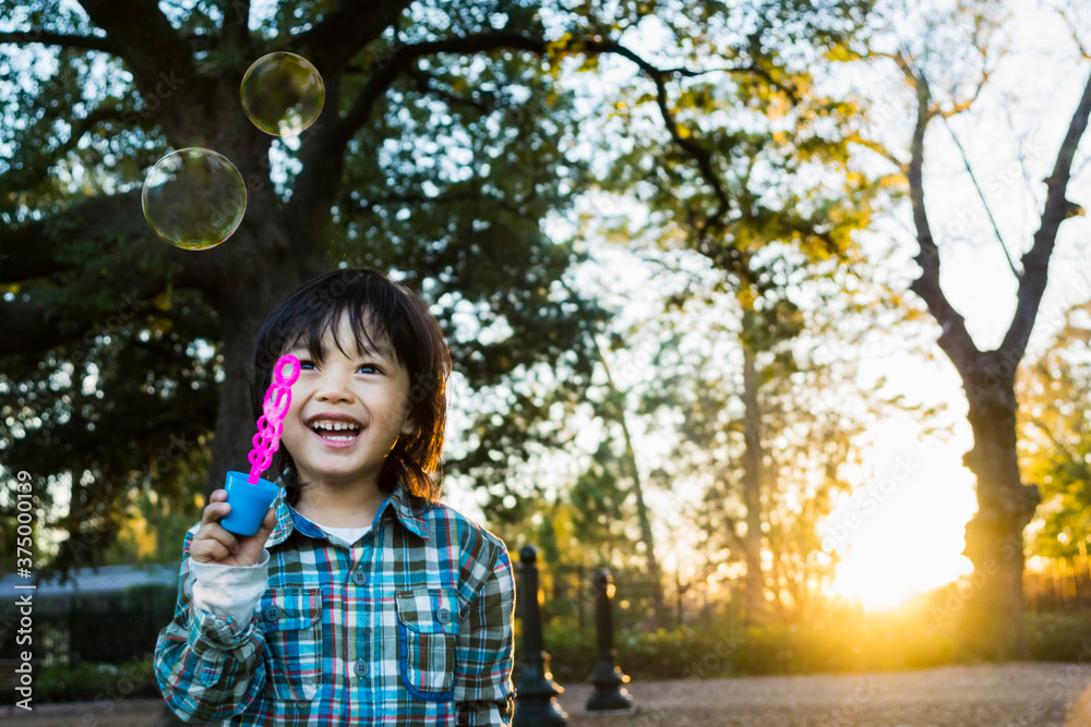 Asian little boy with bubbles at sunset Asian little boy with bubbles at sunset