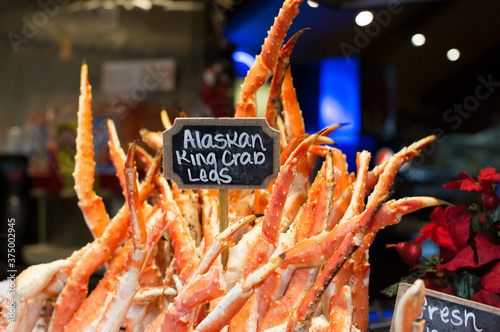 Alaskan king crab legs being sold at an outdoor market photo