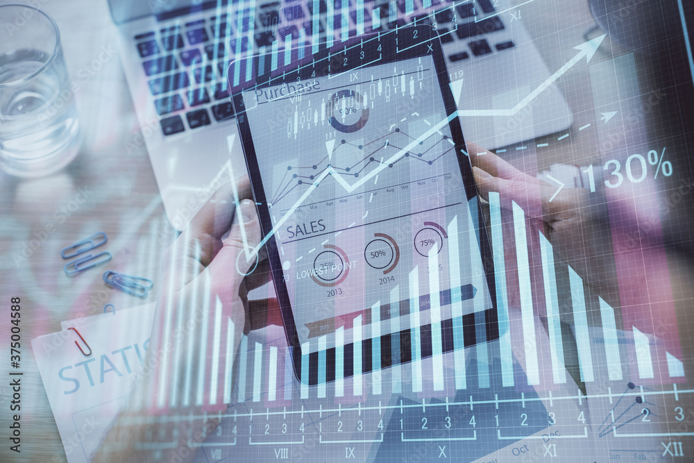Double exposure of man's hands holding and using a digital device and forex graph drawing. Financial market concept. Double exposure of man's hands holding and using a digital device and forex graph drawing. Financial market concept.