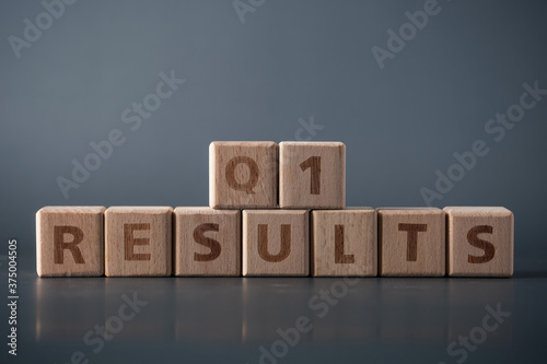Q1 results, wooden block with text. Business concept.