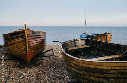 Traditional small wooden fishing boat on the shore.