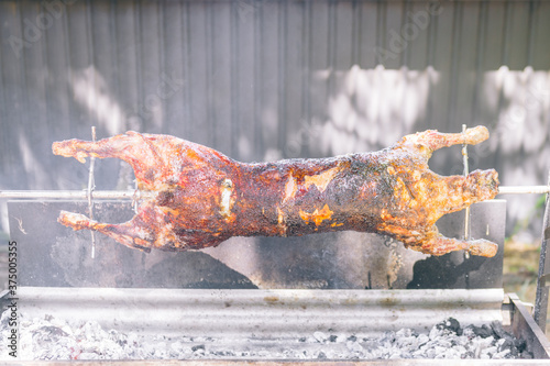 whole lamb roasting on a spit bbq