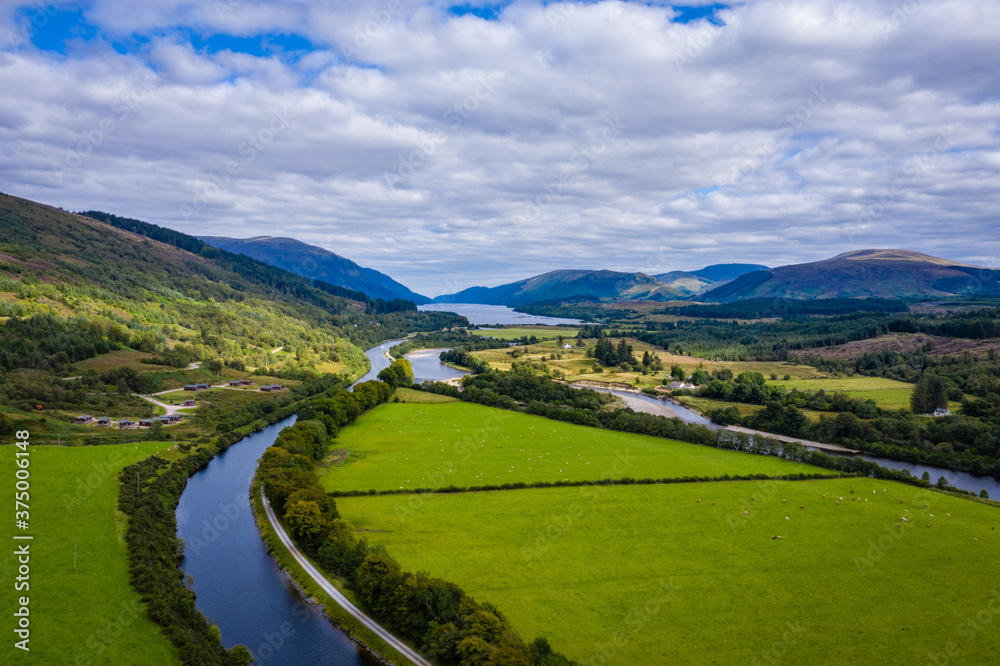 aerial drone footage of summer in gairlochy near fort william on the caledonian canal in the argyll region of the highlands of scotland showing the mountains of glencoe and the surrounding region