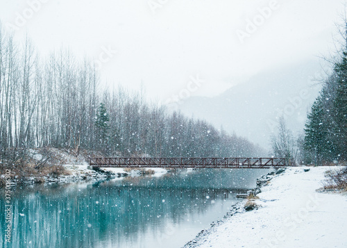 a pedestrian footbridge in falling snow