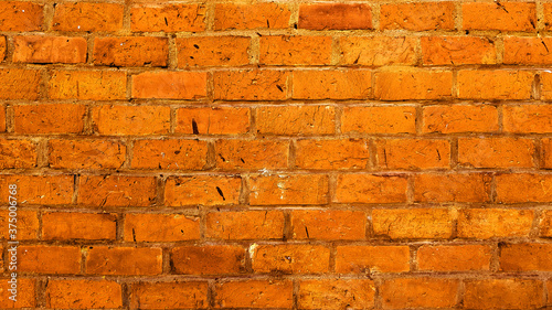 Facade vintage brick stone wall texture orange background.