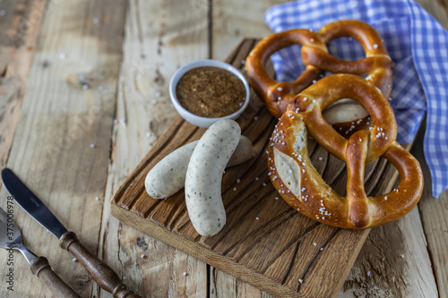 Oktoberfest food. Bavarian meal . White sausages, brezel and sweet mustard on wooden table