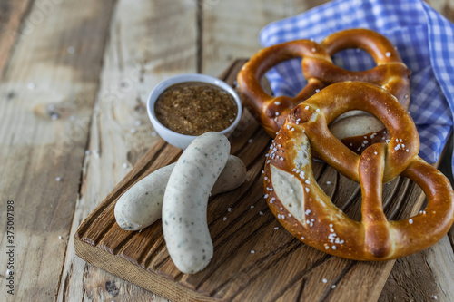 Oktoberfest food. Bavarian meal . White sausages, brezel and sweet mustard on wooden table