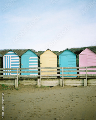 colourful painted beach huts