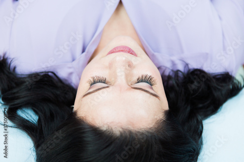 Above view of a young white woman with eyelash extensions