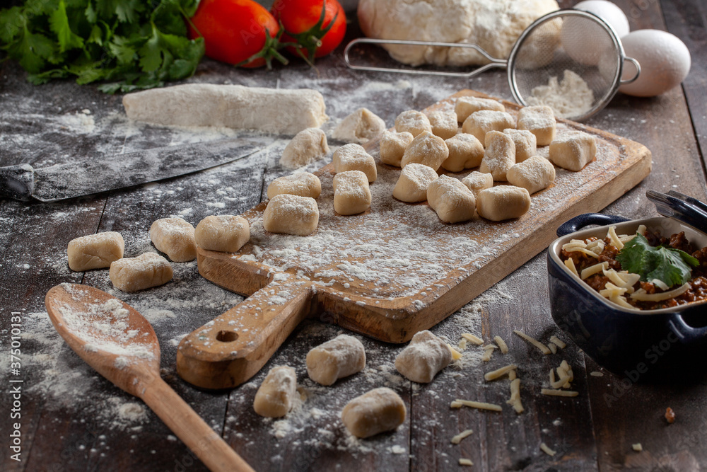 Fototapeta premium gnocchi on a table decorated with ingredients