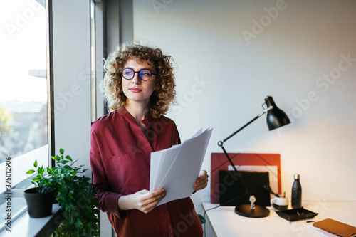 Dreamy freelancer looking out window