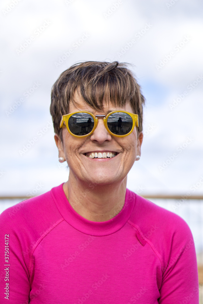 Woman with round glasses smiling Woman with round glasses smiling
