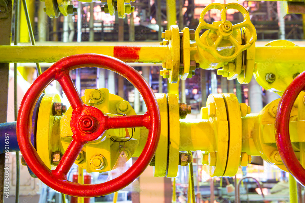 Industrial business. Gas-pipe. Yellow pipes and red gate valves.