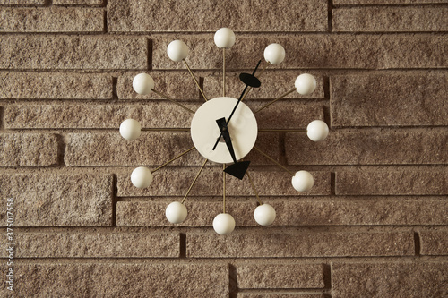 Vintage clock on a wall inside a mid century modern home. photo