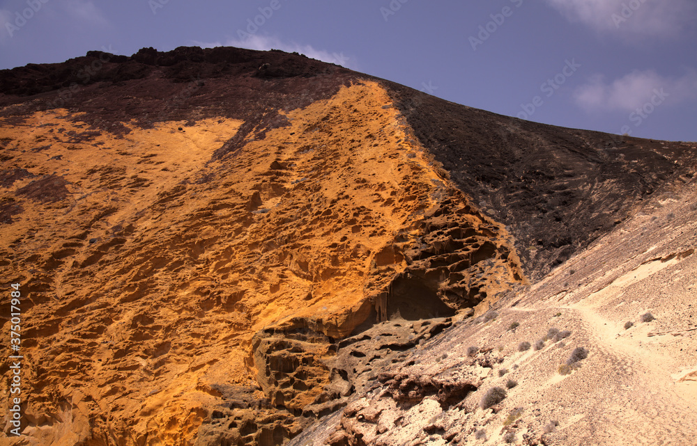 Fototapeta premium Spectacular Montana Amarilla, Yellow Mountain, in different colors of volcanic rock on La Graciosa, Canary Islands