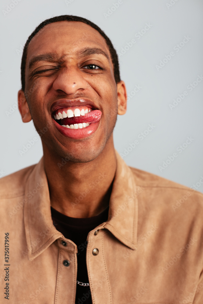Funny black man sticking out the tongue at camera Funny black man sticking out the tongue at camera