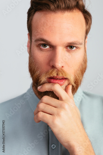 Bearded pensive blonde man in studio