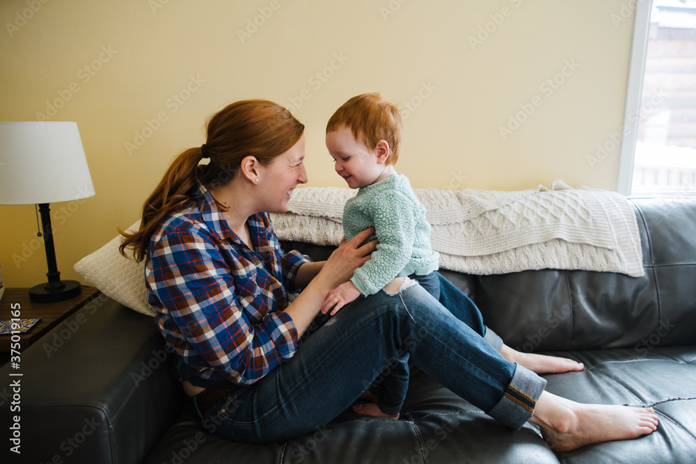 Mom and daughter spending quality time together at home - playin Mom and daughter spending quality time together at home - playin