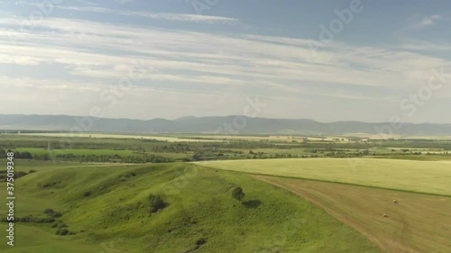 Wallpaper Mural Scenic aerial panoramic view of idyllic rolling hills spring landscape in with lush green mountain pastures in evening light at sunset Torontodigital.ca