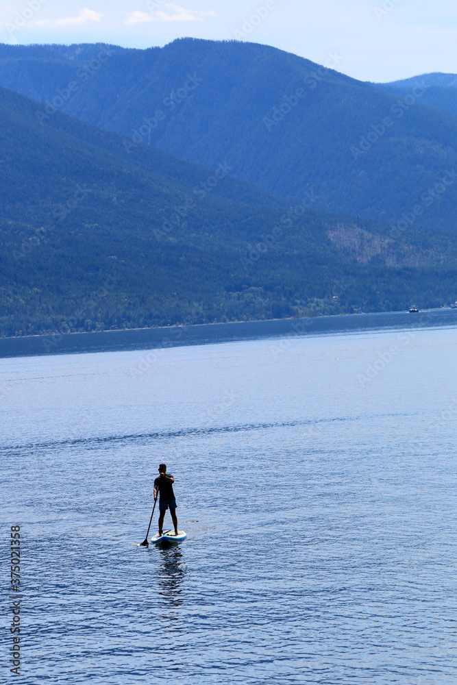 Naklejka premium Paddle boarding in mountain lake 