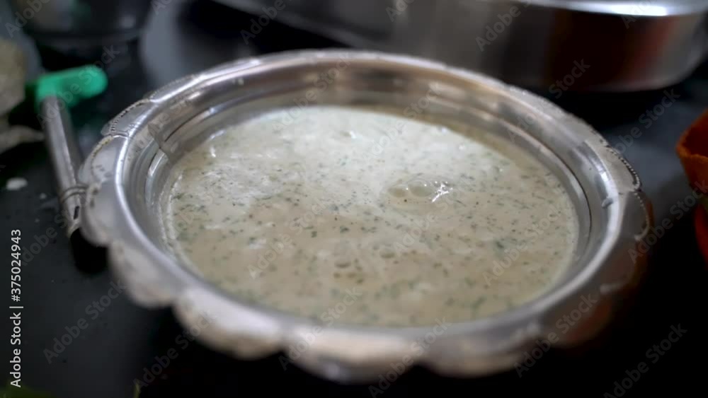 Amti Maharashtrian Soup On A Silver Platter. - Close up shot Amti Maharashtrian Soup On A Silver Platter. - Close up shot