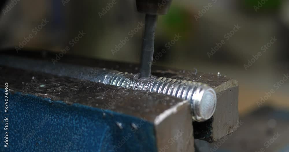 Close up of professional craftsman lubricating drill. High friction causes smoke from the drill. Close up of professional craftsman lubricating drill. High friction causes smoke from the drill.