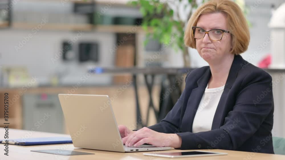Sad Old Businesswoman with Laptop showing Yes Sign Sad Old Businesswoman with Laptop showing Yes Sign