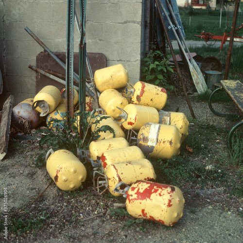 Pile of yellow discarded gas tanks. Buffalo Minnesota MN USA photo